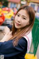 A woman in a school uniform posing for a picture.