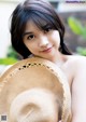 A woman in a straw hat posing for a picture.